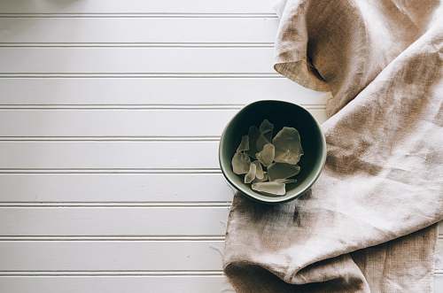 sea glass gray ceramic bowl beside gray textile glass